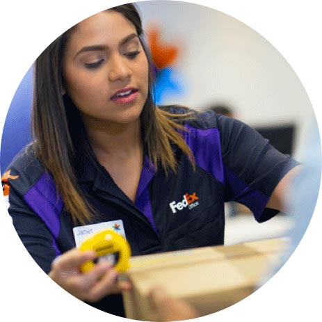 FedEx employee wrapping up a package