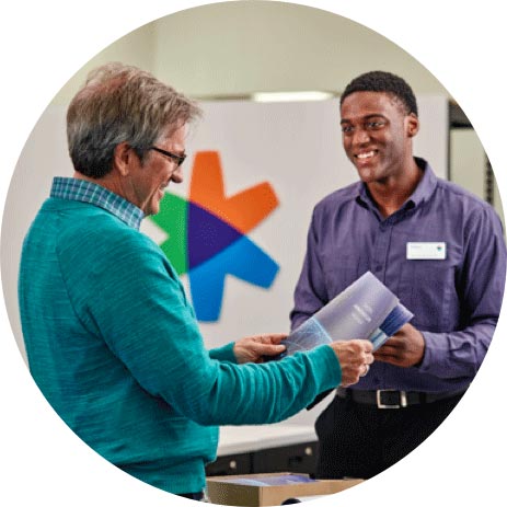 FedEx employee helping a customer with design