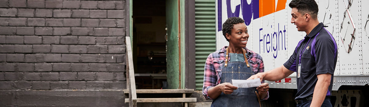 smiling woman holding fedex package