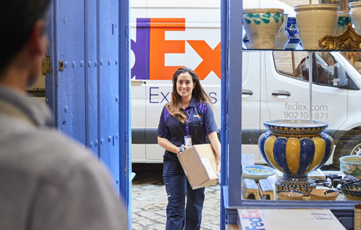 fedex delivery driver delivering package to small business