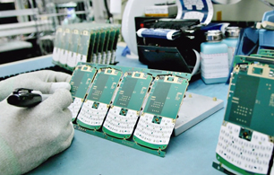 A lab worker tests a microship on a circuitboard.
