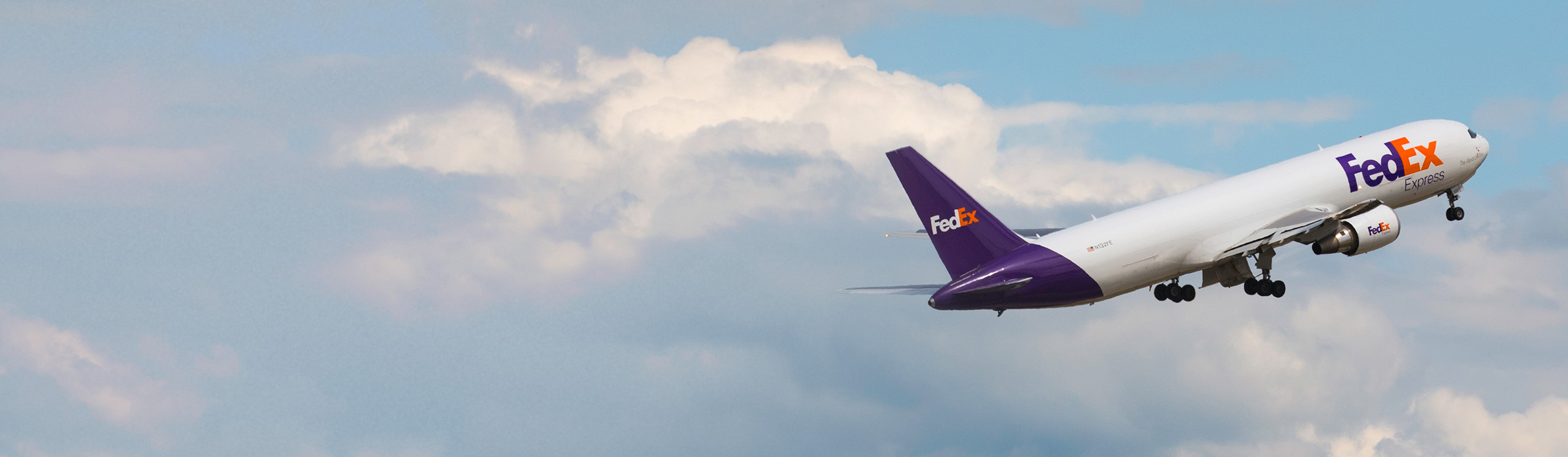 FedEx plane above the clouds