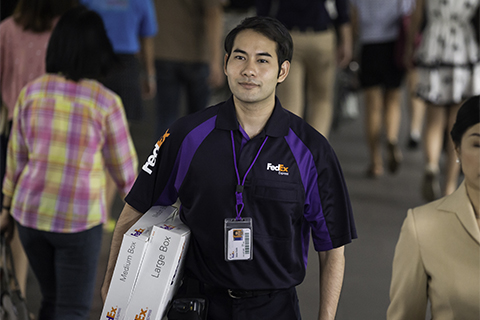 A FedEx Express employee delivers a package