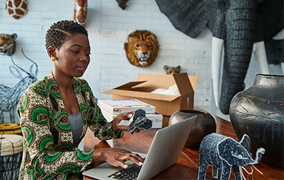A woman uses her laptop to download the Shipper Resources guide