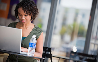 A FedEx customer works on her laptop