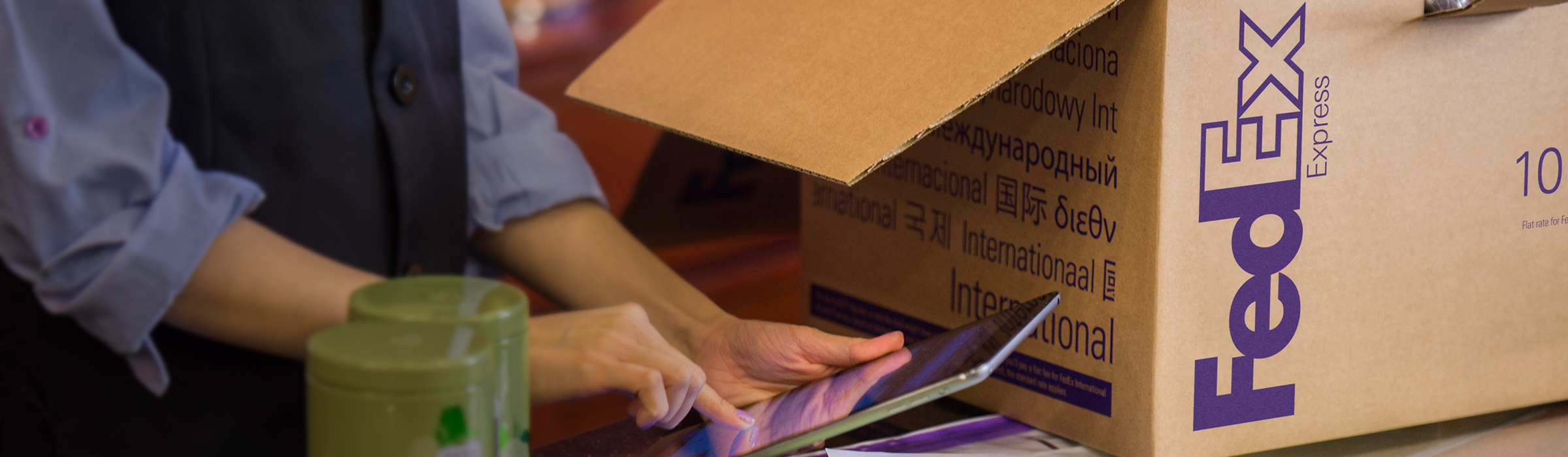 Boutique employee using tablet to ship supplies