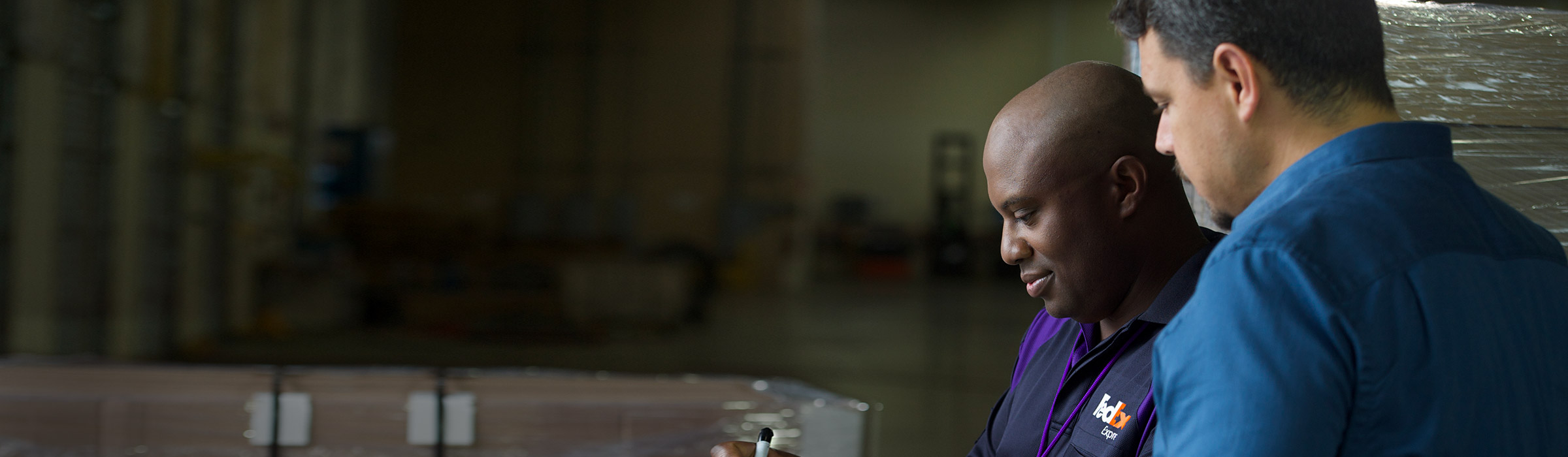 FedEx team member helping customer in warehouse