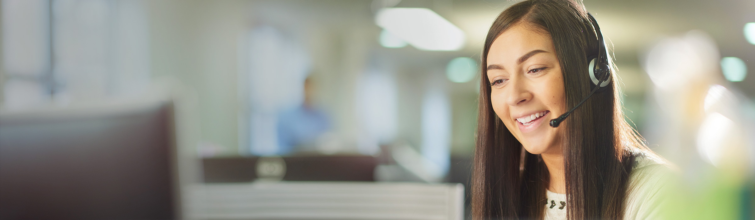 A customer service representative talking through a headset.
