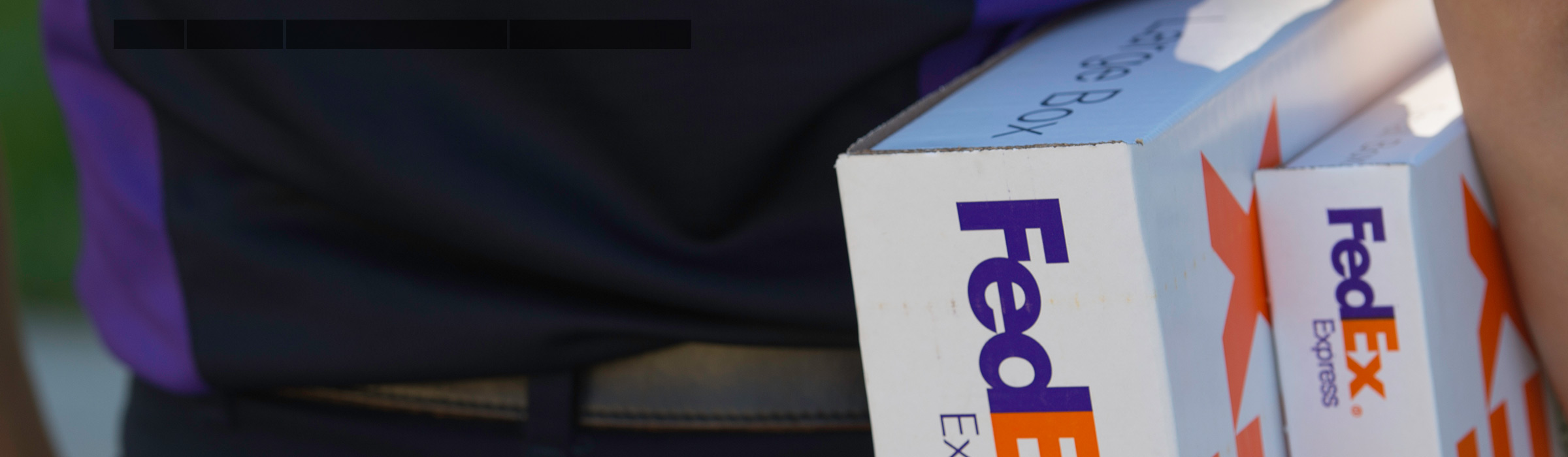 FedEx courier holding on to FedEx Express packages