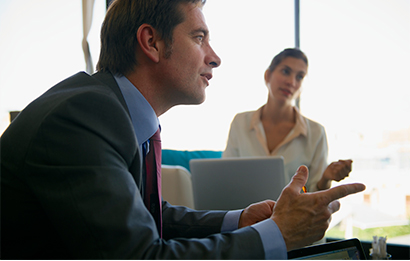 A FedEx account executive gestures while describing the FedEx Technology Incentive program