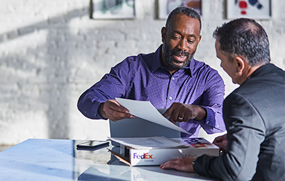 Two men talking inventory logistics