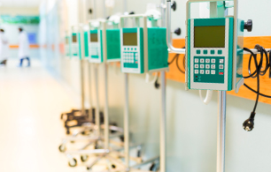 Close-up of infusion pumps In a hospital corridor.