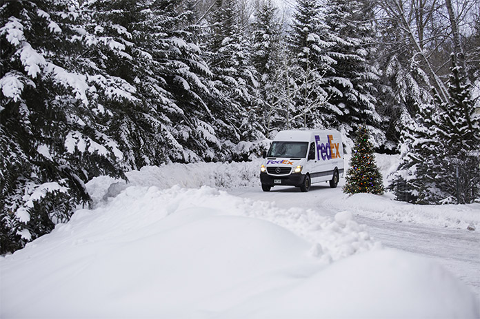 FedEx van driving on snowy road