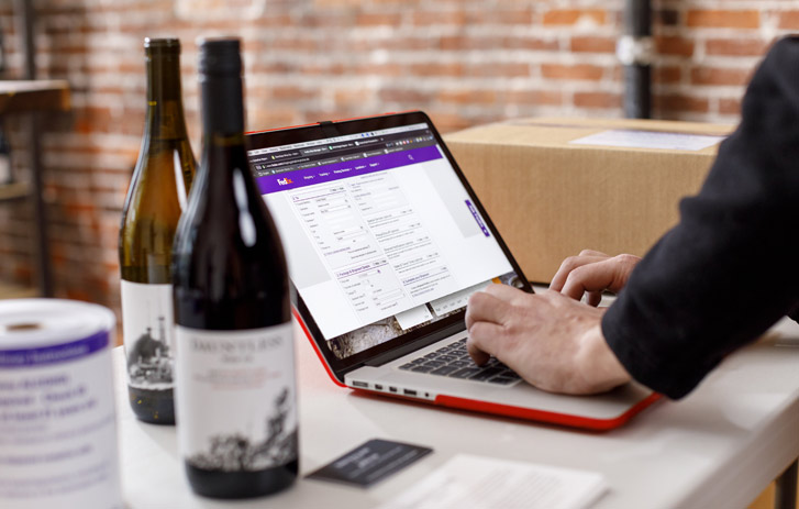 A photo of a person processing a wine shipment online
