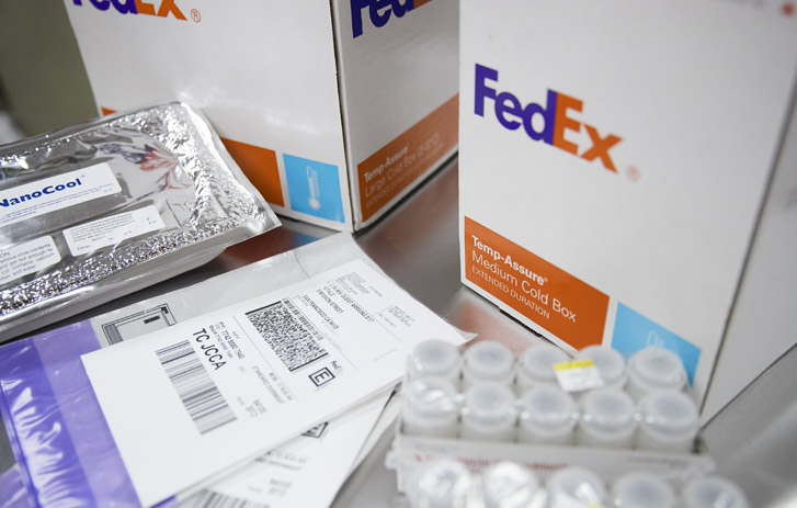 vials next to fedex packaging and shipping label