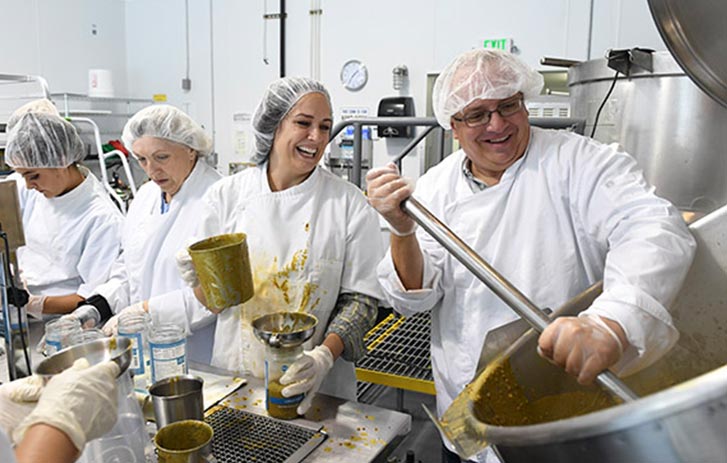 A photo of the Gina Cucina team cooking soup in an industrial kitchen.