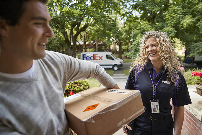 courier delivers package with dangerous goods label to customer