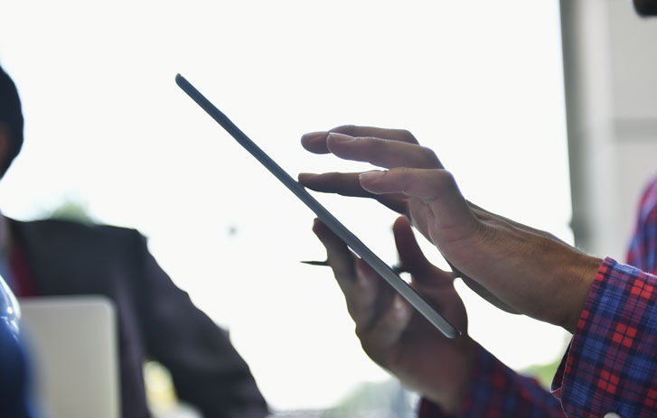 Person shipping on tablet