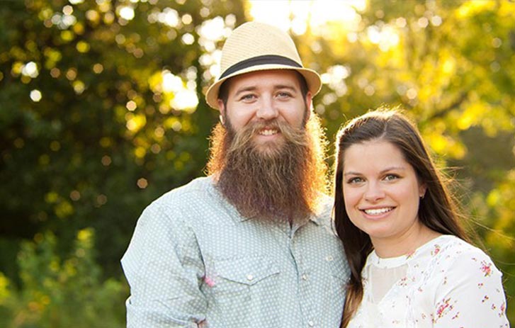 A photo of Ryan and Brittany Lane, owners of Dream Beard, standing outside.