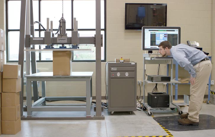 A photo of a packaging engineer testing a package