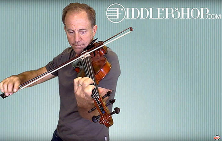 A photo of Pierre Holstein playing a fiddle