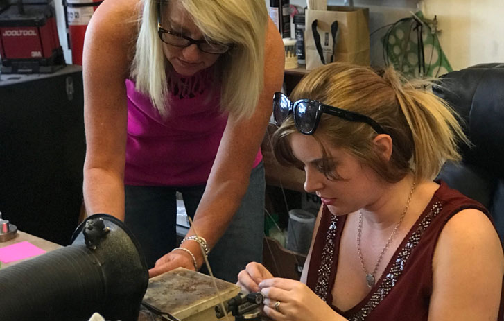 A photo of Heidi Hale and another woman working on a project