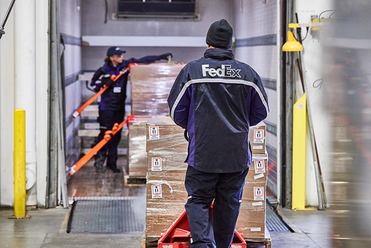 Courier loads large cardboard boxes