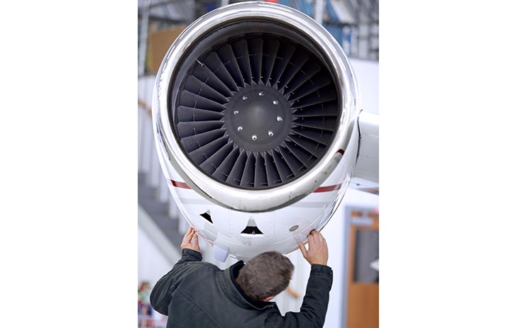 airplane technician checks plane engine
