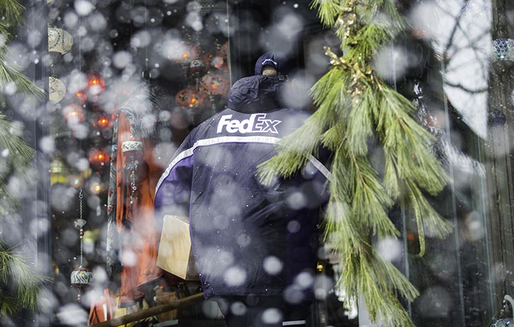 fedex delivery driver delivering package in Canada