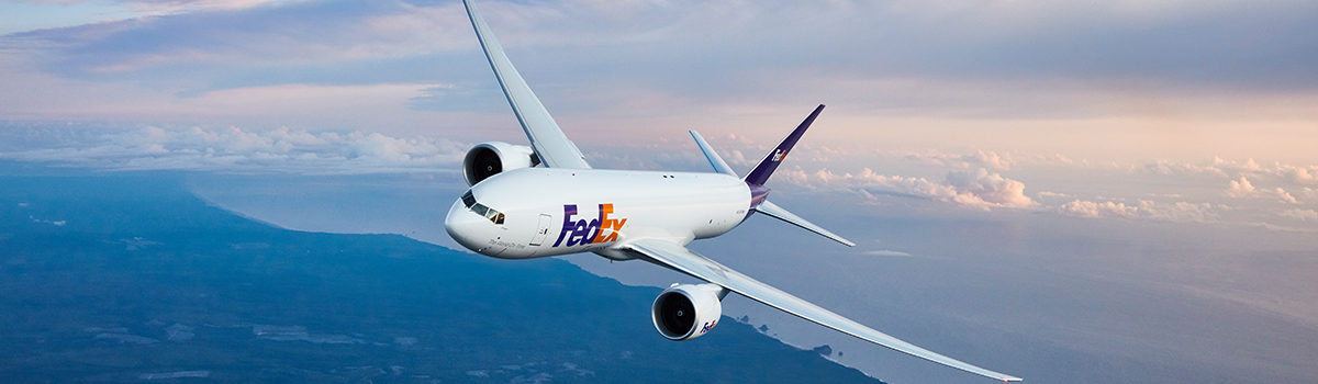 A FedEx airplane soaring through the sky.