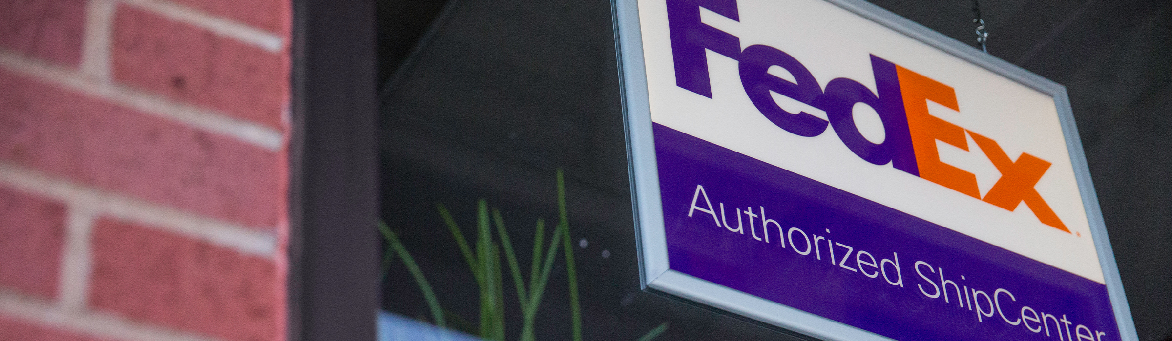 FedEx Authorized ShipCenter® (FASC) store sign.