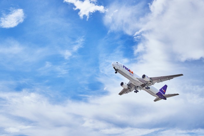 FedEx plane flying in the sky.