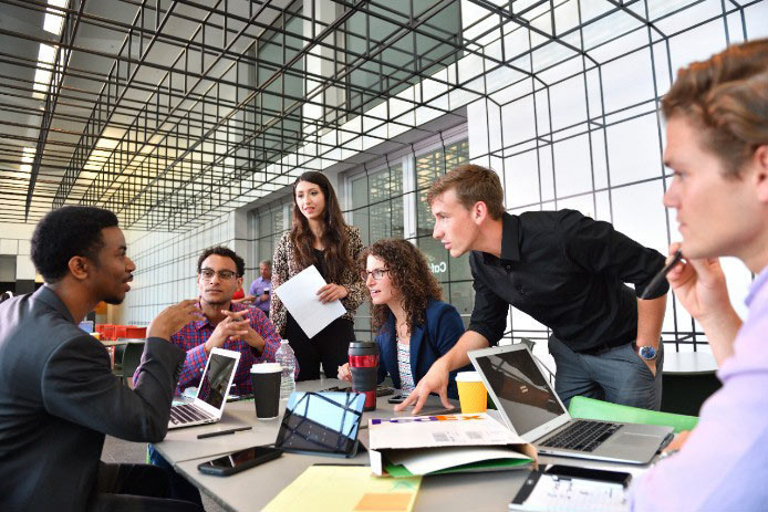 People working and conversing around a table