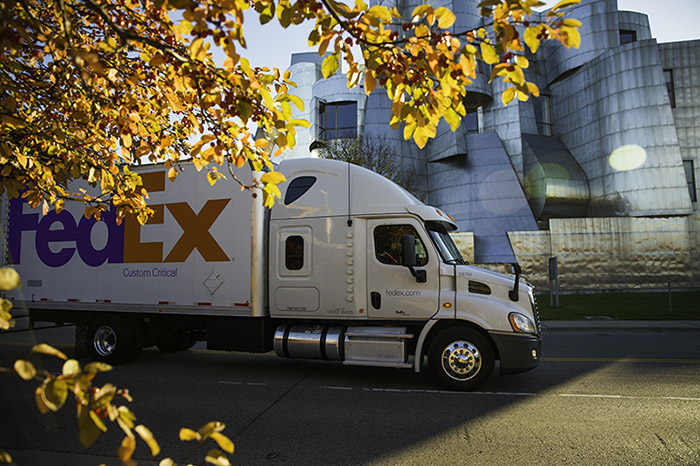 FedEx Custom Critical truck drives outside metal building