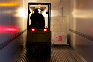 Red lights from forklift shine in corridor