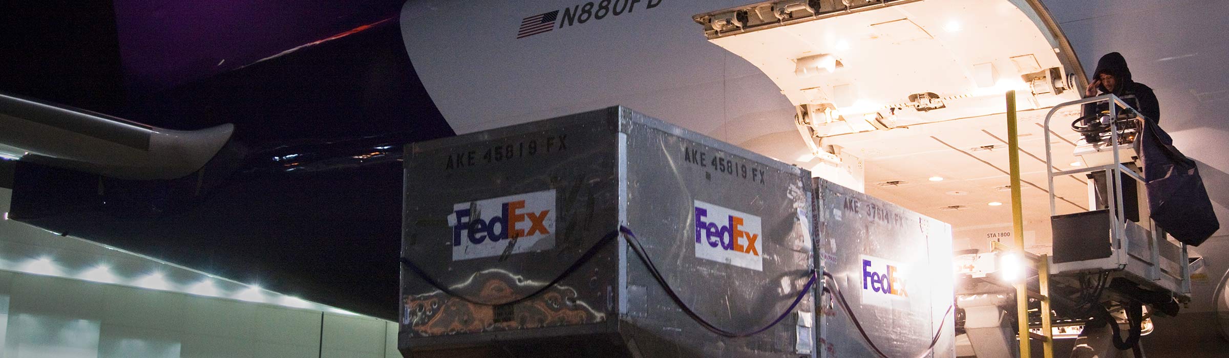 Large containers getting loaded onto airplane