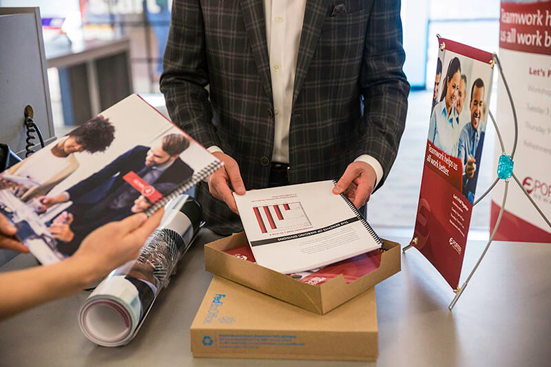 FedEx Office customer reviewing his order
