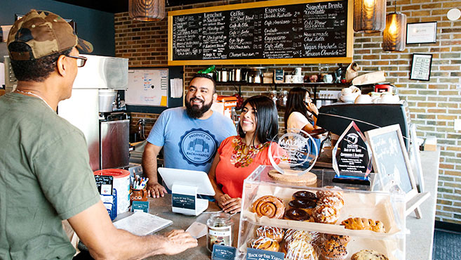 customer and business owners in a coffee shop