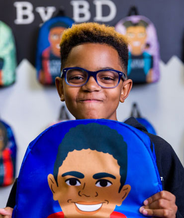 Boy holding backpack