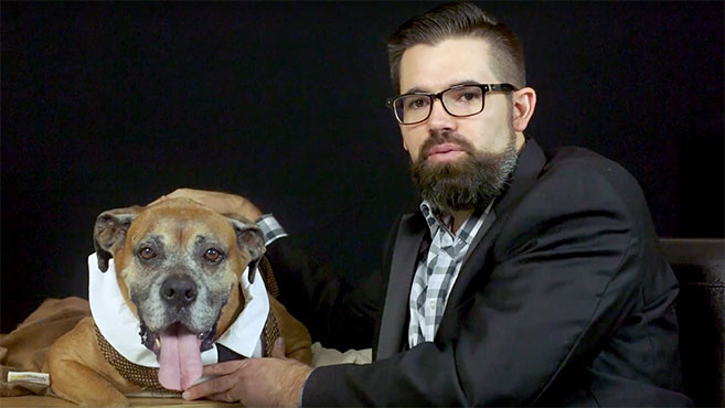 Man sitting next to his dog