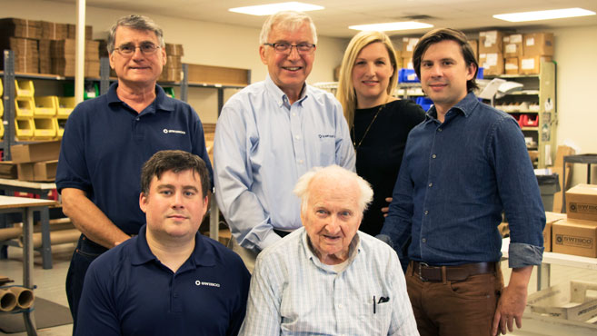 Family posing in business mailroom