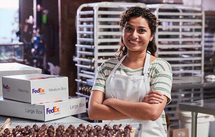proud business owner standing over desserts