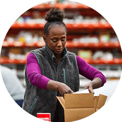 Woman packing a box in a warehouse.