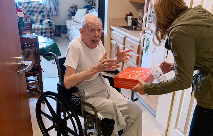 A photo of Purpose, The Therapeutic owner giving the patient a branded box.