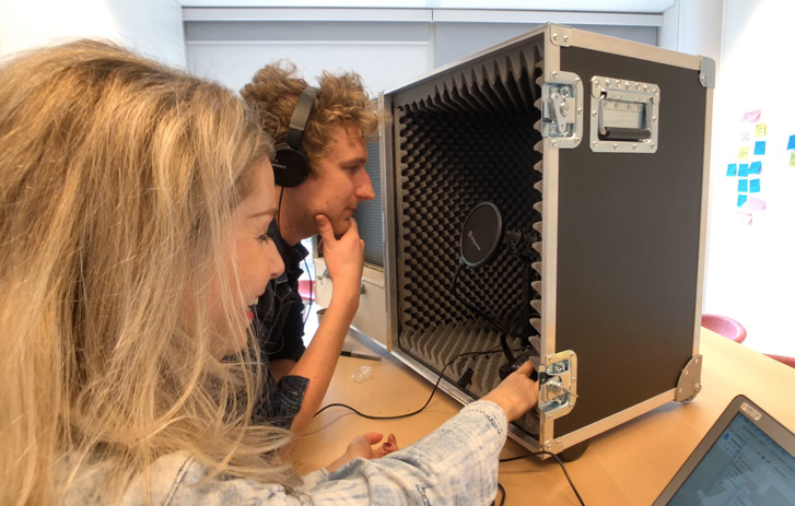 Tom and Kelli working with a portable podcast studio speaker
