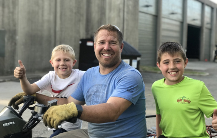 Pit Barrel Cooker Co. family smiling on four wheeler