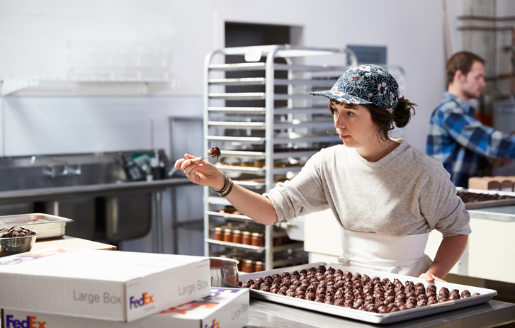 worker packaging goods in kitchen