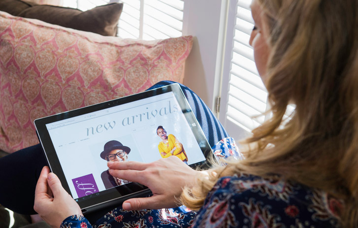 woman browsing e-commerce website on tablet