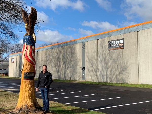 Picture of Noah Glanville in front of Pit Barrel business