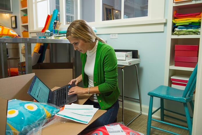 Woman on laptop in a textile room
